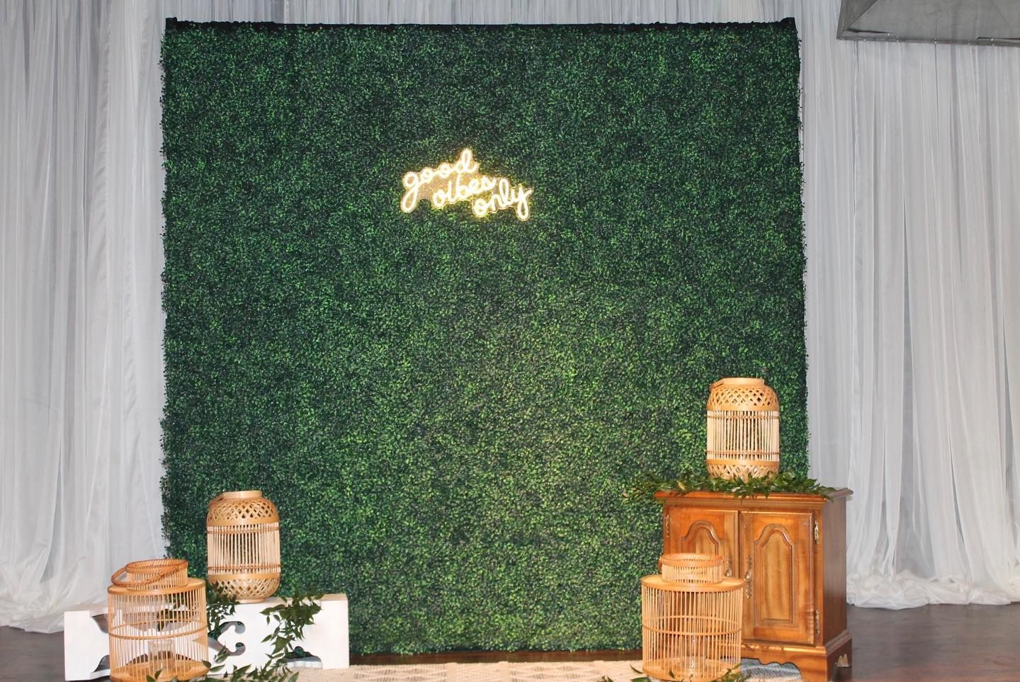 There is a green wall with a neon sign on it.