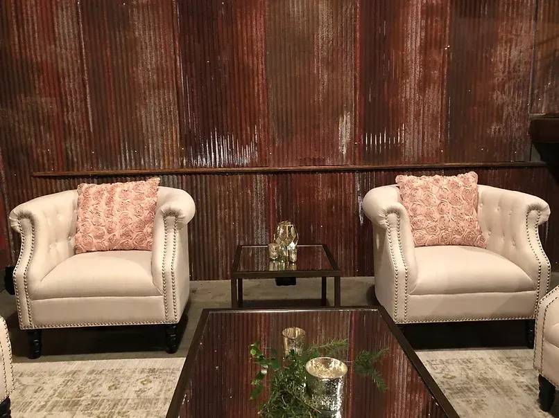 There are two chairs and a coffee table in the room.