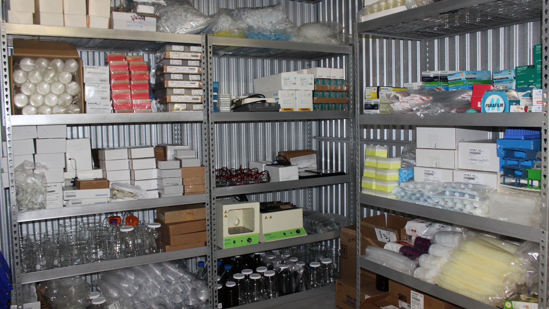 Science and lab equipment on shelving in a storage facility