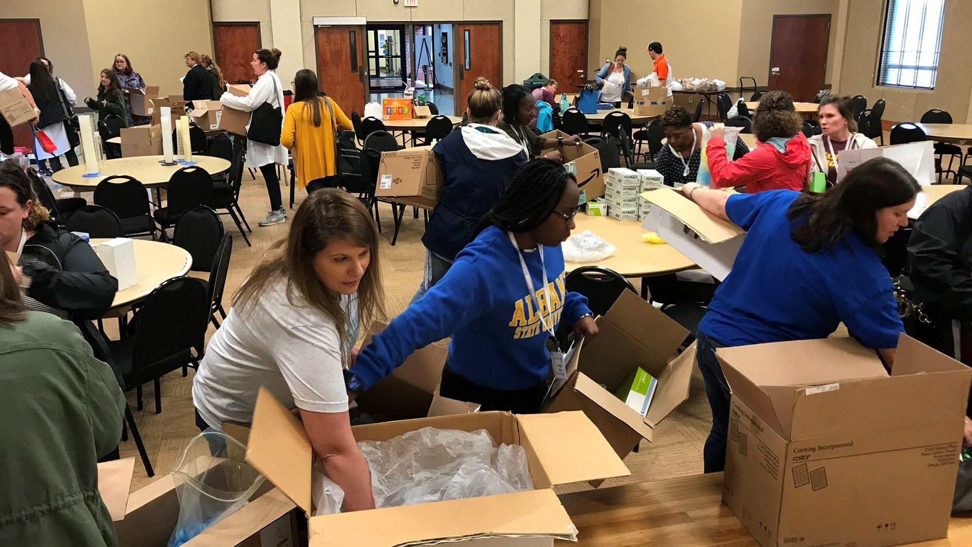 Volunteers and educators sorting supplies at the GABIO Equipment Depot