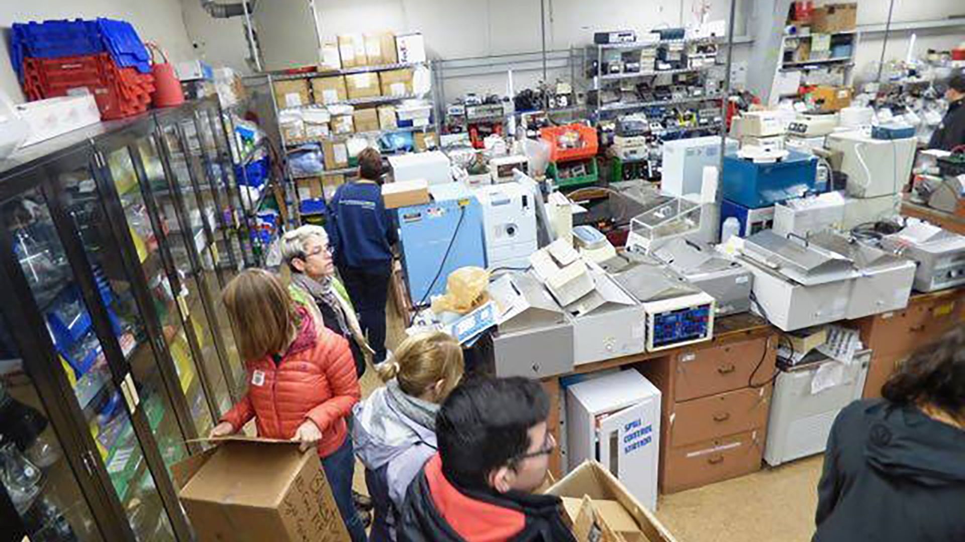 Educators sorting science lab equipment and supplies at the GABIO Equipment Depot