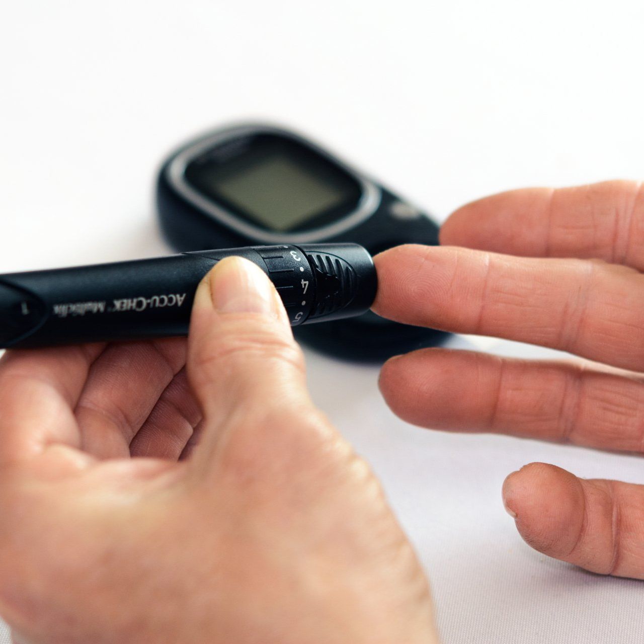 Person using blood sugar detecting medical device