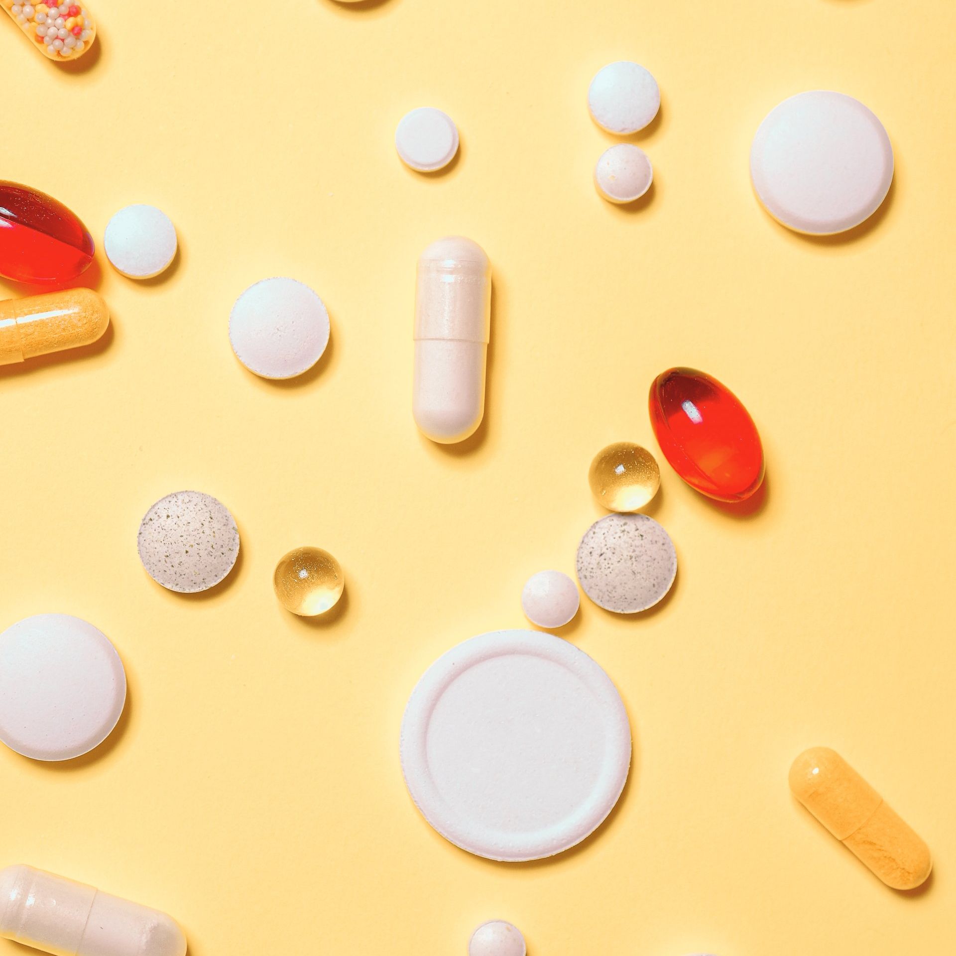Assorted medications on a yellow Assorted medications on a yellow backgroundbackground