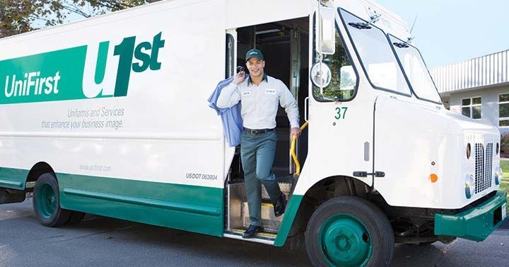 Delivery driver stepping out of a Unifirst truck