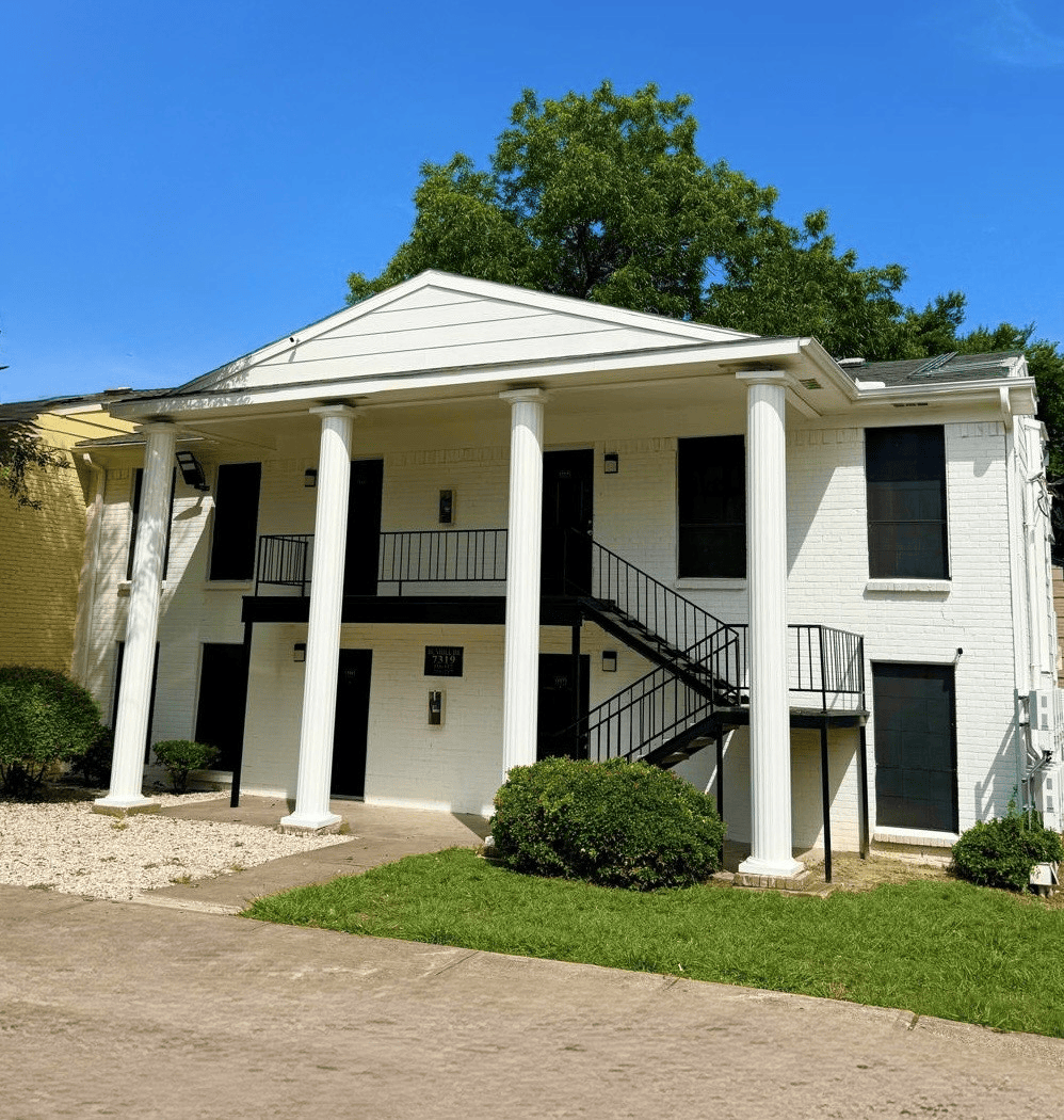 A large white house with columns and stairs
