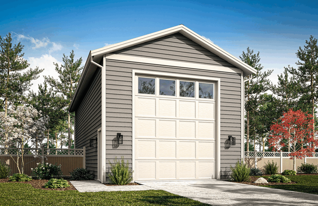 Small gray garage with white door, gabled roof, and a paved driveway in a landscaped yard.
