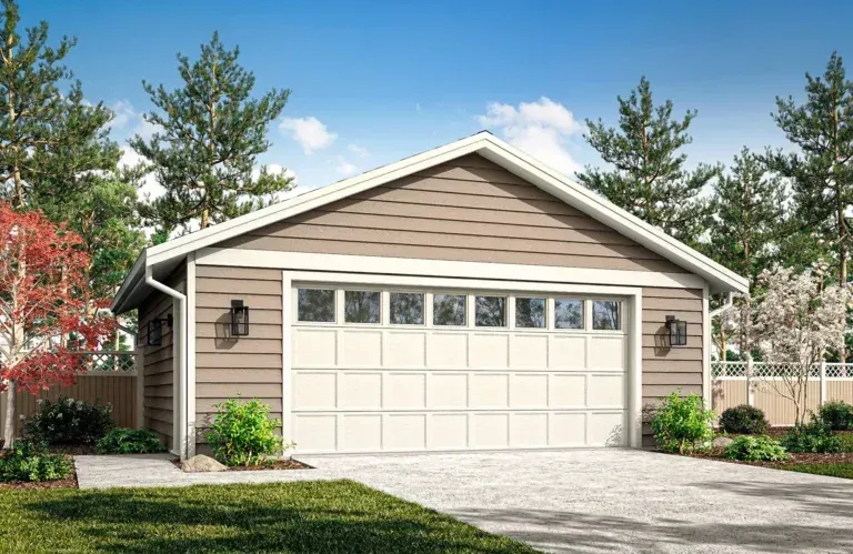 Single-story beige garage with white doors, front lawn, and trees under a clear blue sky.