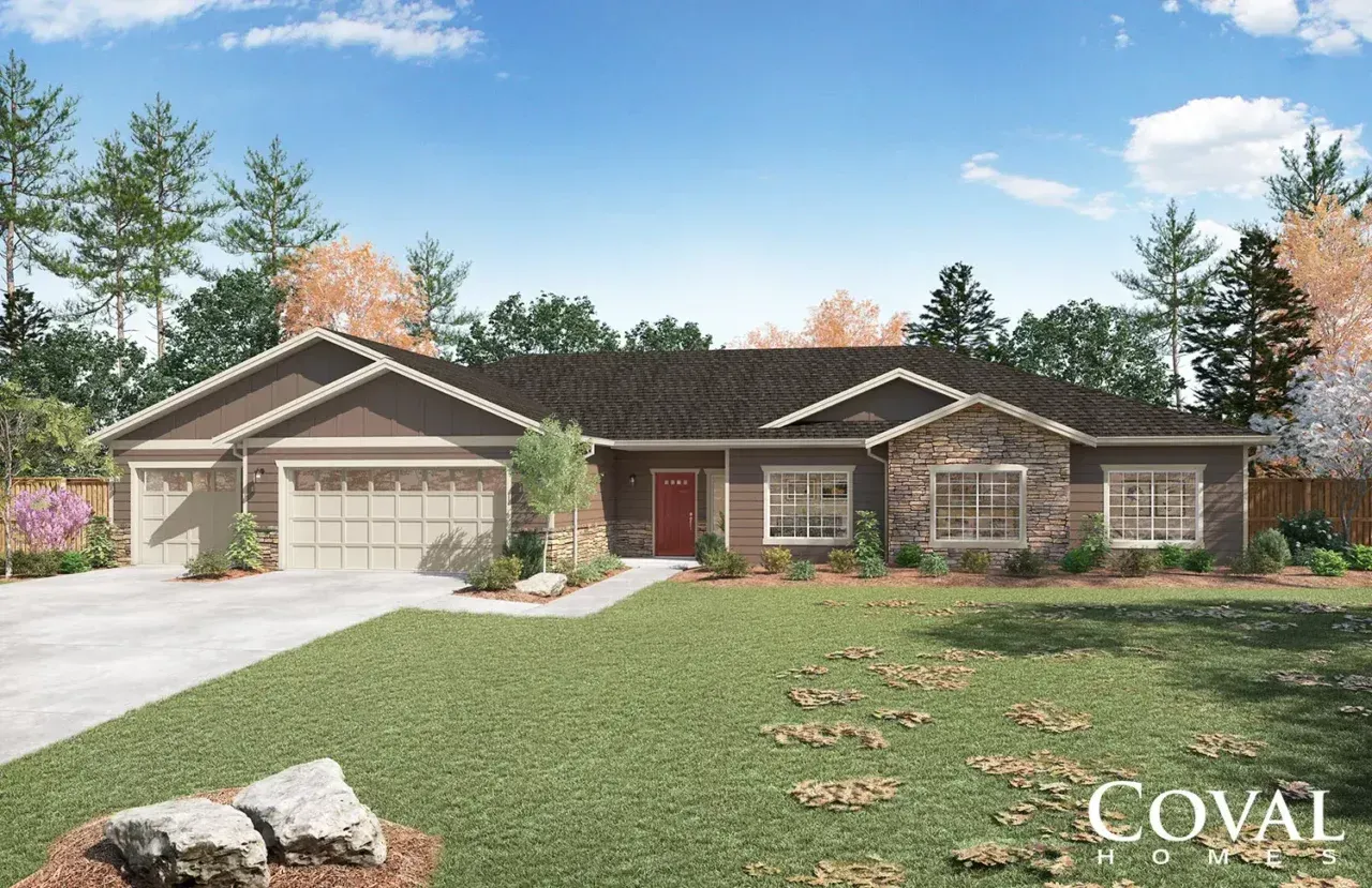 Single-story suburban house with a two-car garage, brick exterior, and a large green lawn.
