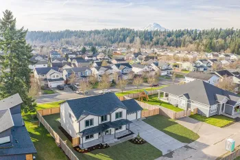 Suburban neighborhood with modern houses and tree-lined streets on a sunny day