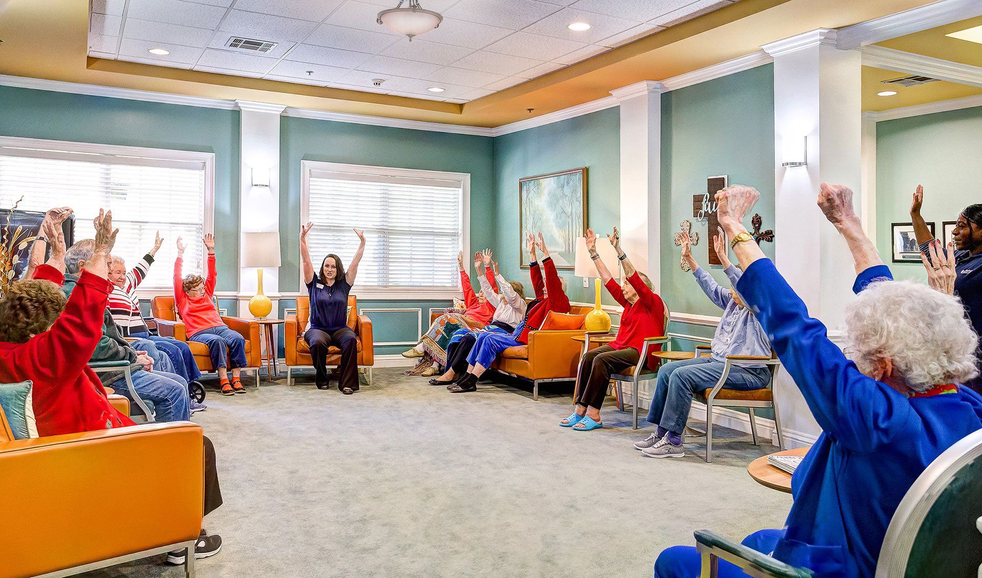 A group of elderly people are doing exercises in a living room.