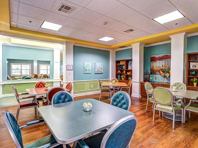 There are many tables and chairs in this room.