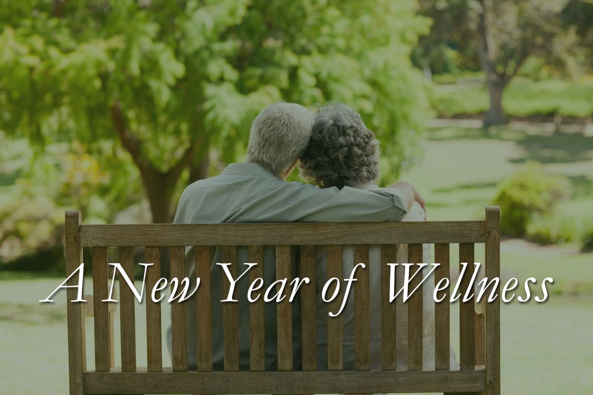 Couple sitting on park bench, embracing, with 
