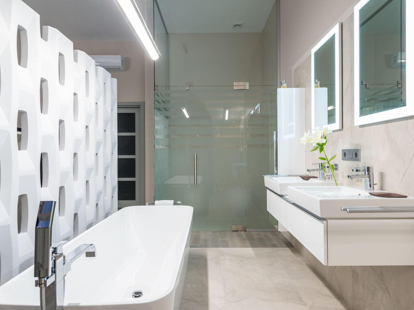 Modern white bathroom with a bathtub, floating vanity, glass shower, and large mirror