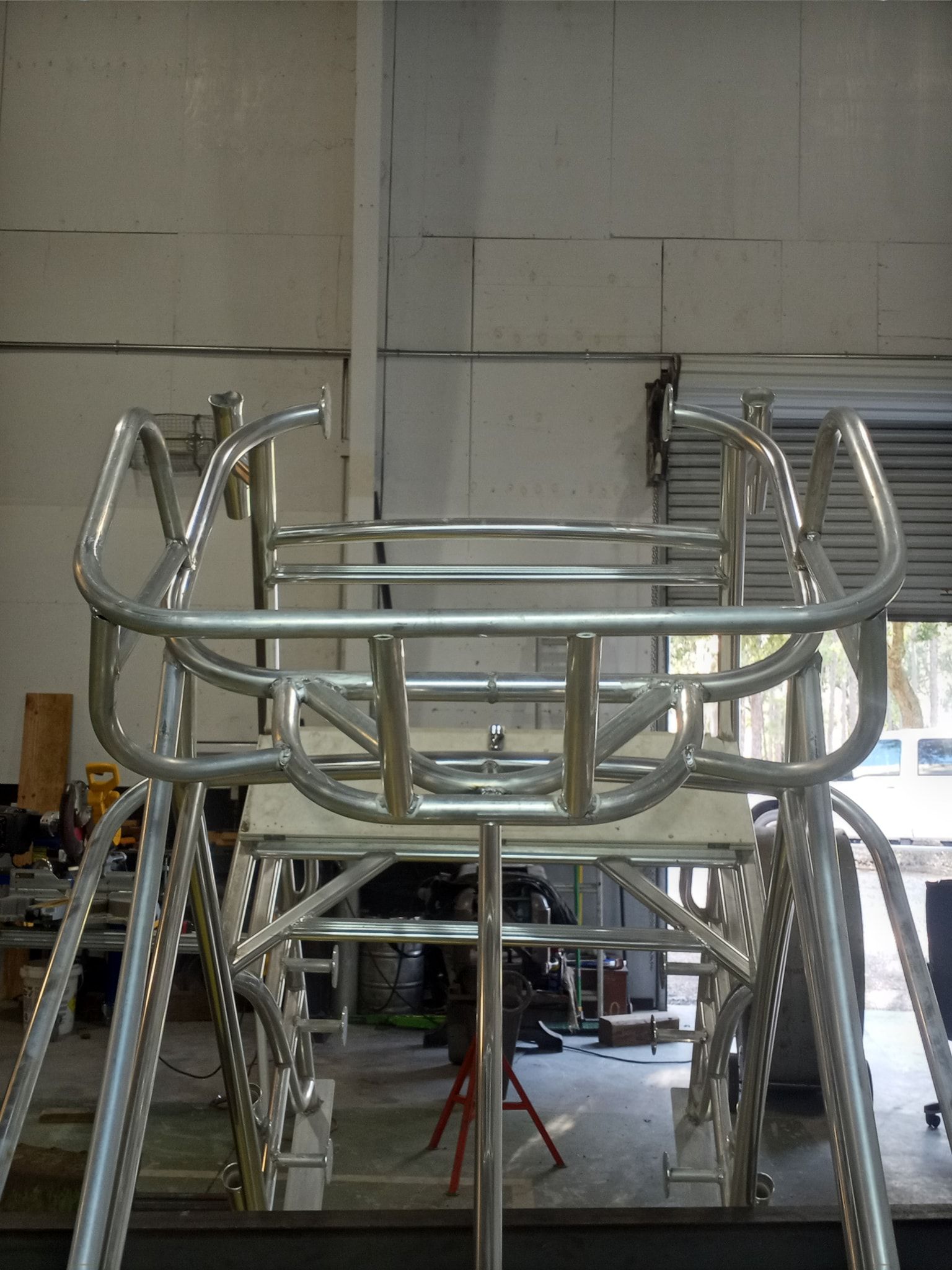 Metal boat structure framework under construction. Silver metal rails and bars create the framework.