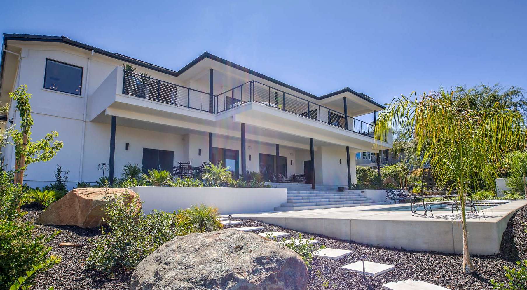 exterior view of contemporary home with beautiful landscape