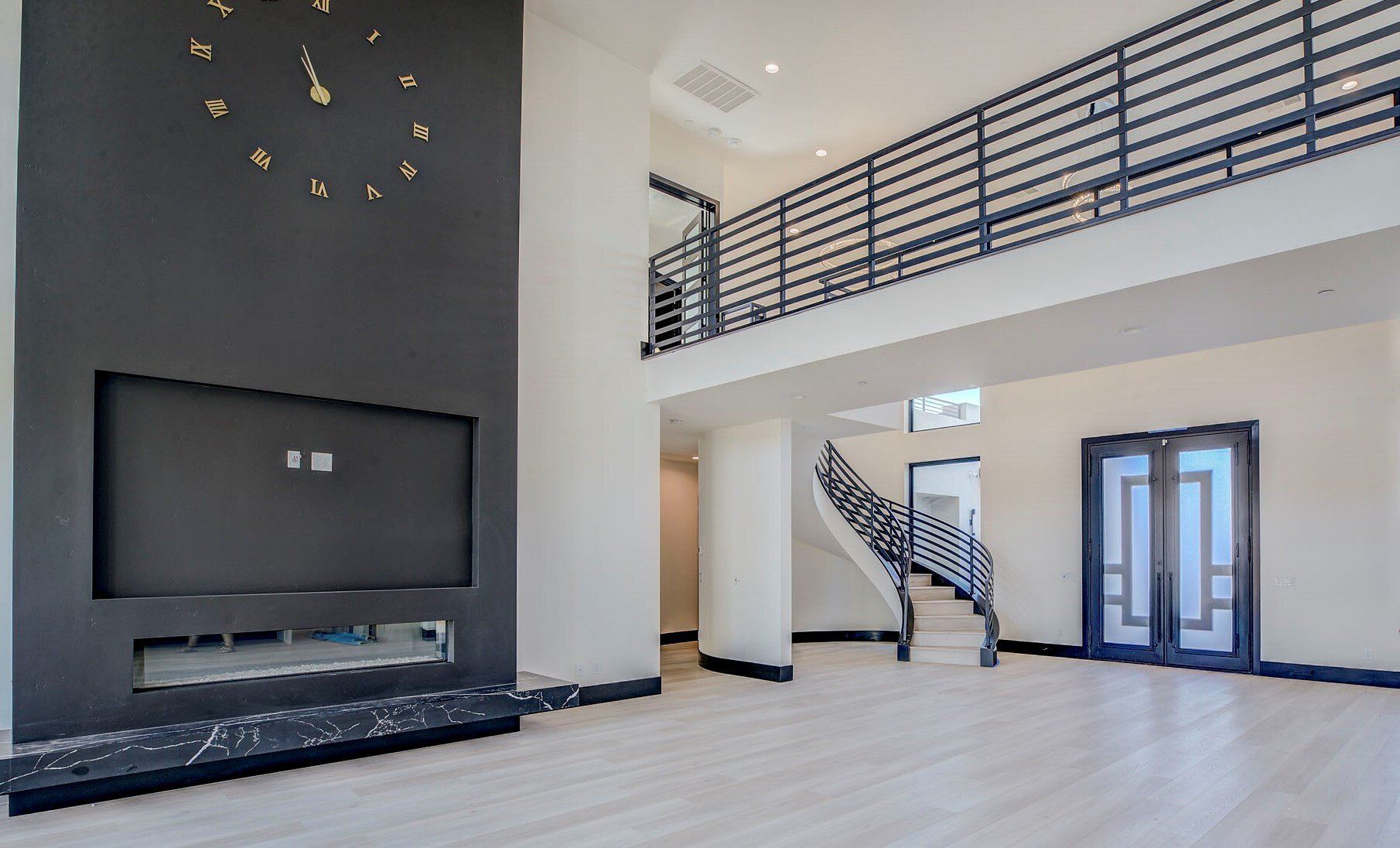 Great room with a linear fireplace and 21 ft ceilings