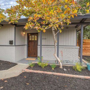 house with white exterior paint and flat roof