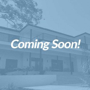 front view of house with upper deck and porch