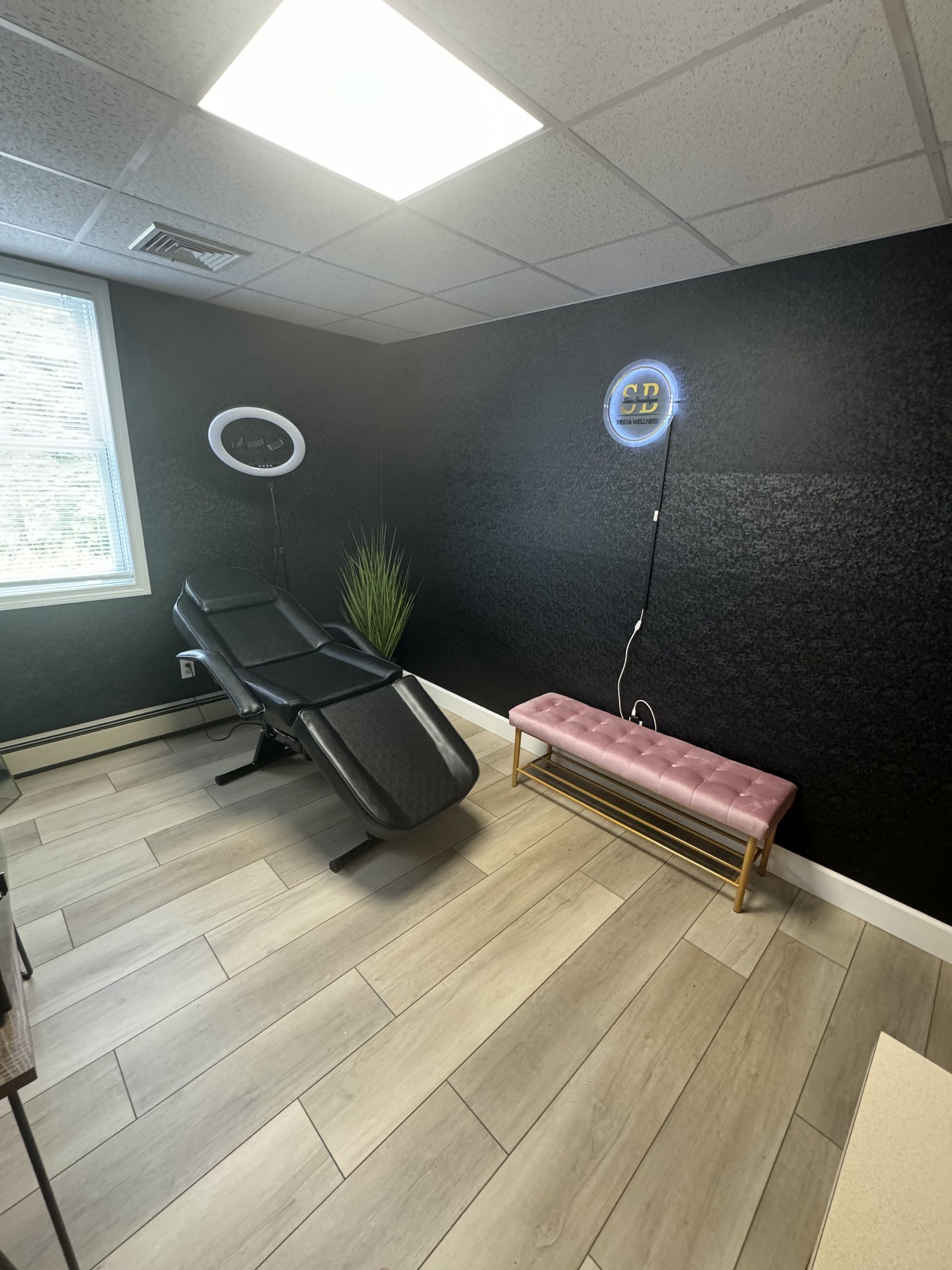 A room with a chair and a bench in it.