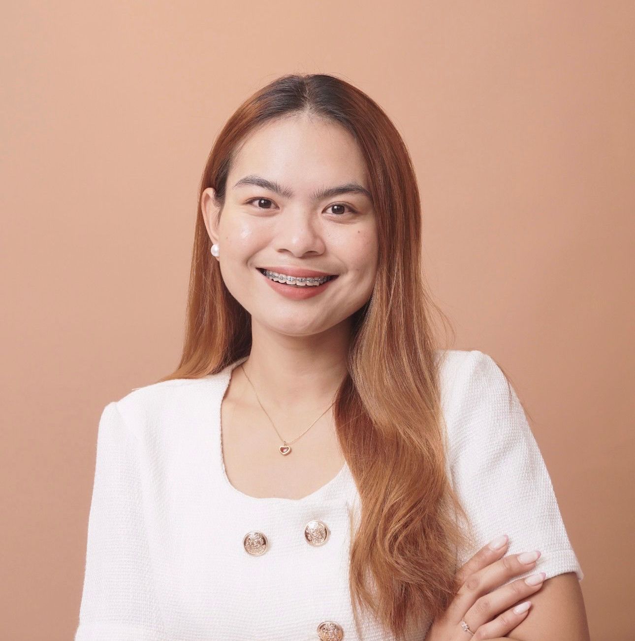 The woman is wearing a black turtleneck and smiling for the camera.