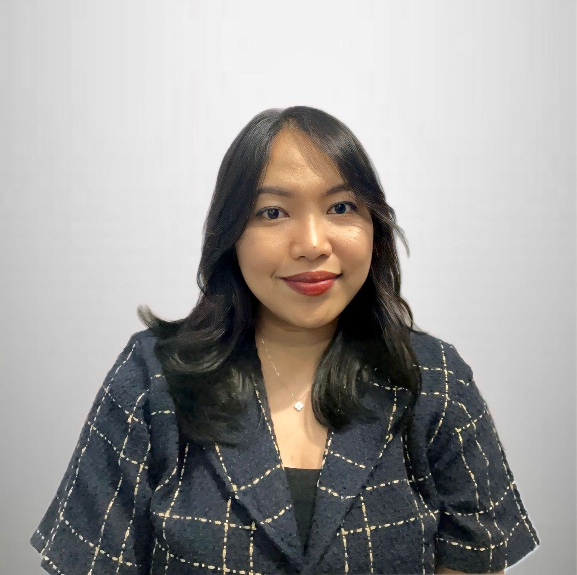 A woman wearing a black turtleneck is looking at the camera