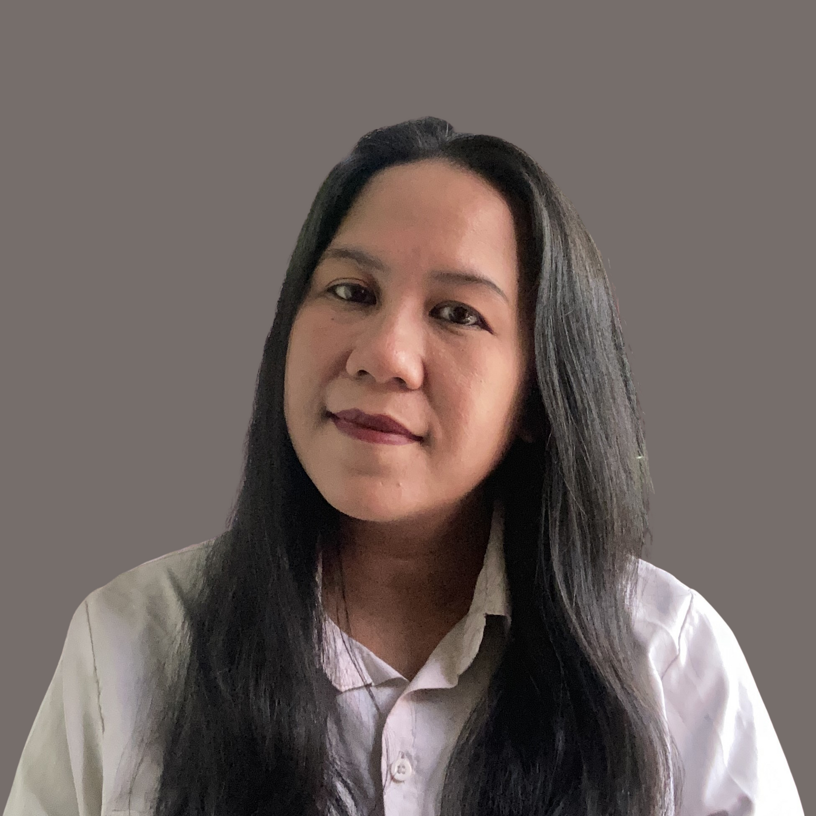 A woman wearing a white jacket and necklace smiles for the camera