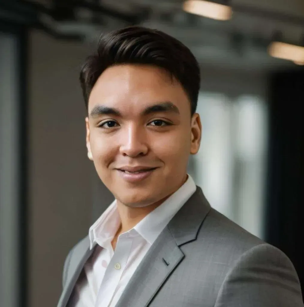 A man in a suit and white shirt is smiling for the camera.
