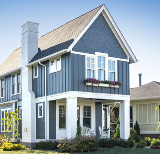 A blue and white house with a chimney on the roof