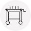 A hand-cranked grilling cart with smoke rising from the grill.