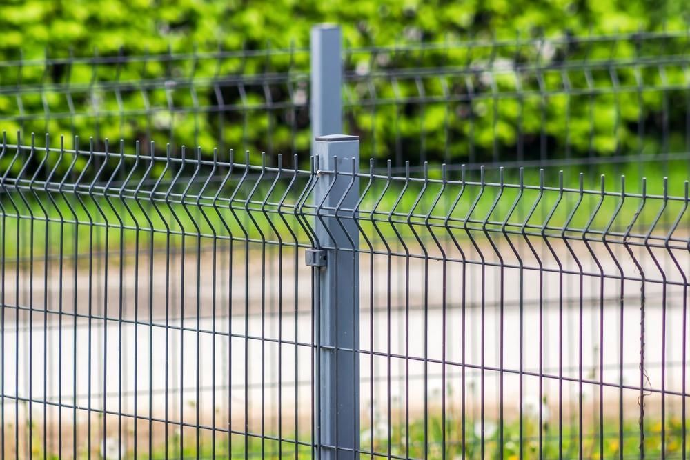 a Close Up of a Metal Fence With a Post in the Middle of It — Tony Sinclair Fencing In Coffs Harbour, NSW