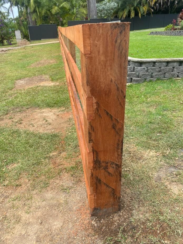 a Wooden Fence is Sitting in the Middle of a Lush Green Field — Tony Sinclair Fencing In Bucca, NSW