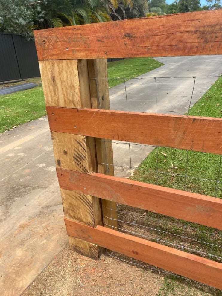 a Close Up of a Wooden Fence With Barbed Wire — Tony Sinclair Fencing In Bucca, NSW