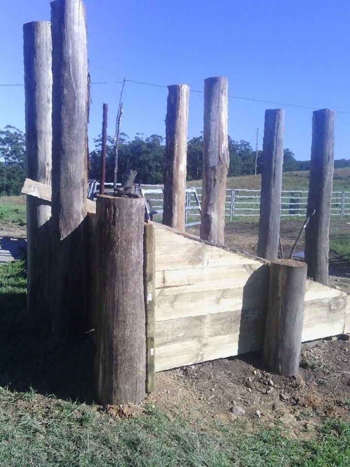 a Wooden Structure is Sitting in the Middle of a Grassy Field — Tony Sinclair Fencing In Bucca, NSW