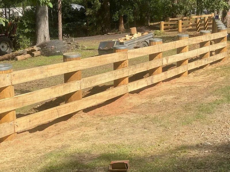 a Wooden Fence is Being Built in a Grassy Field — Tony Sinclair Fencing In Bucca, NSW