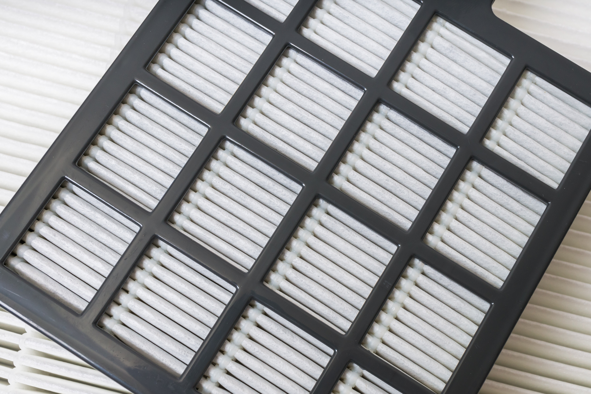 A close up of a vacuum cleaner filter on a white surface.