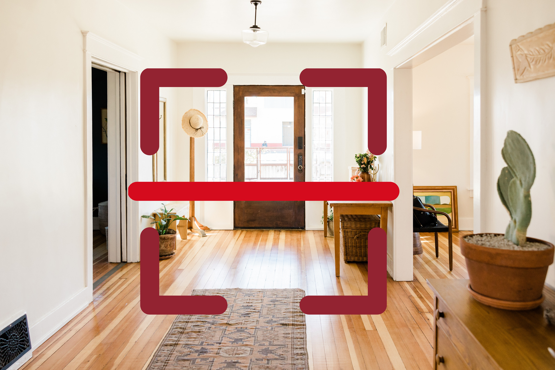 A hallway with hardwood floors and a cactus in a pot.