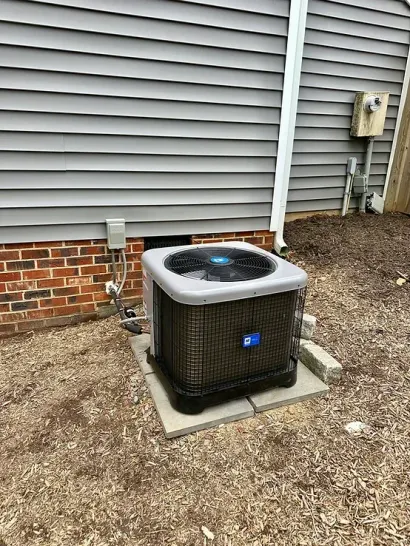 An air conditioner is sitting outside of a brick house.