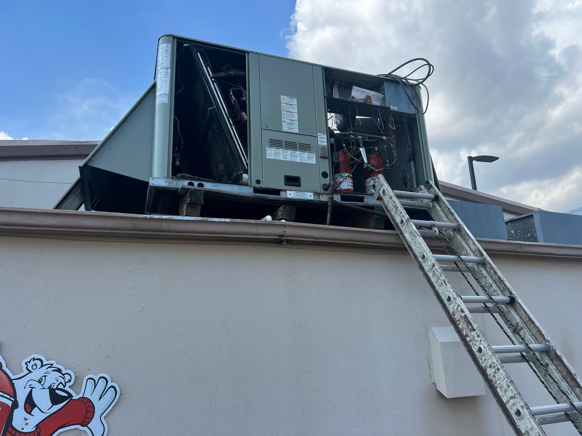 Person using a wrench on a water heater in a utility room.