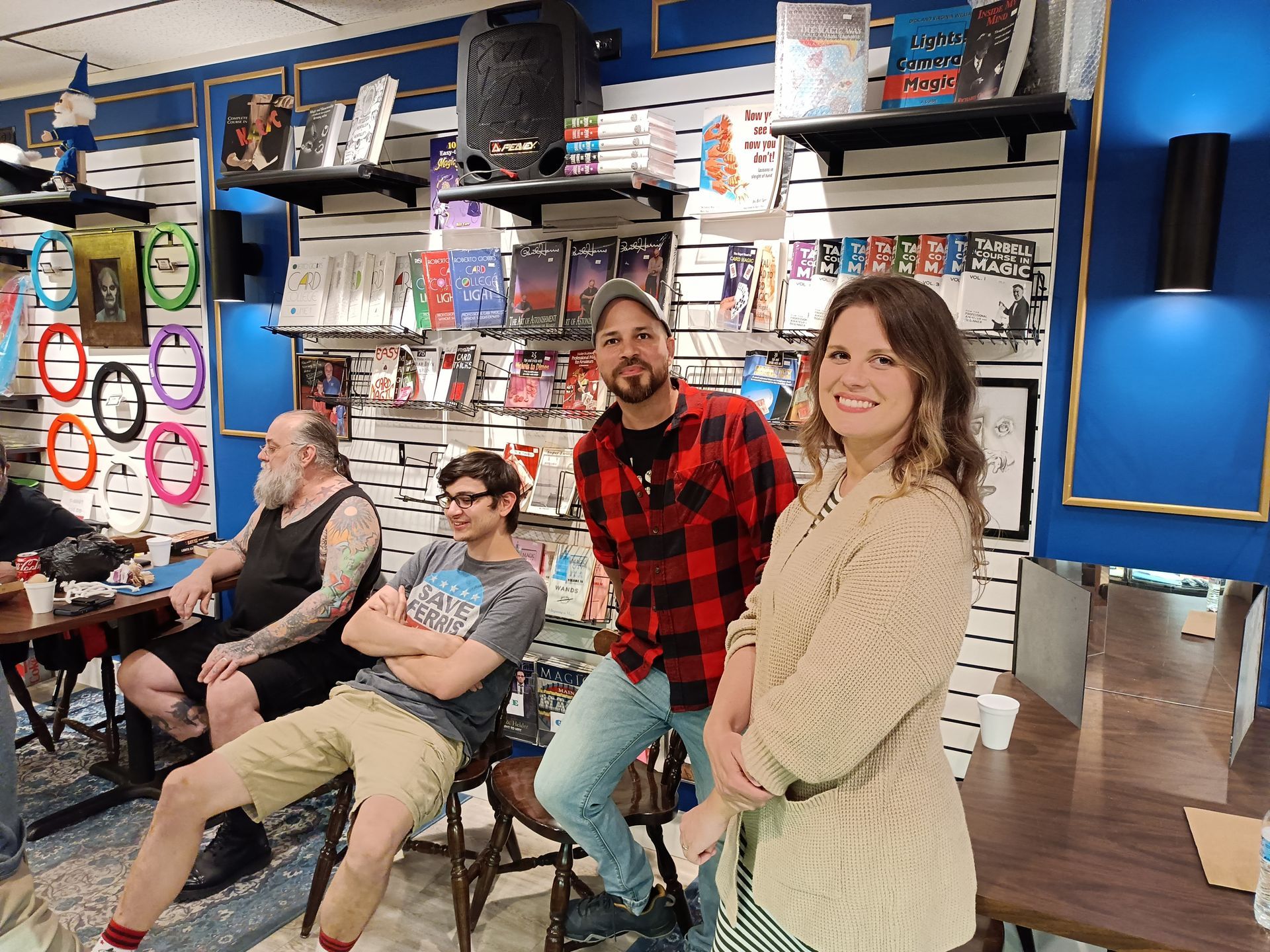 Three men are looking at a display case in a store.