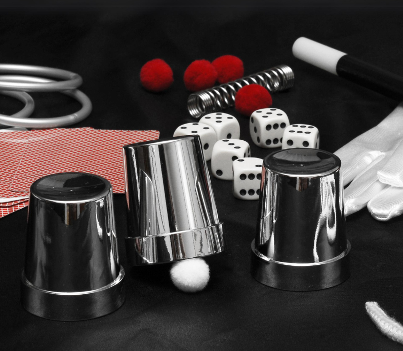 A set of silver cups and dice on a table