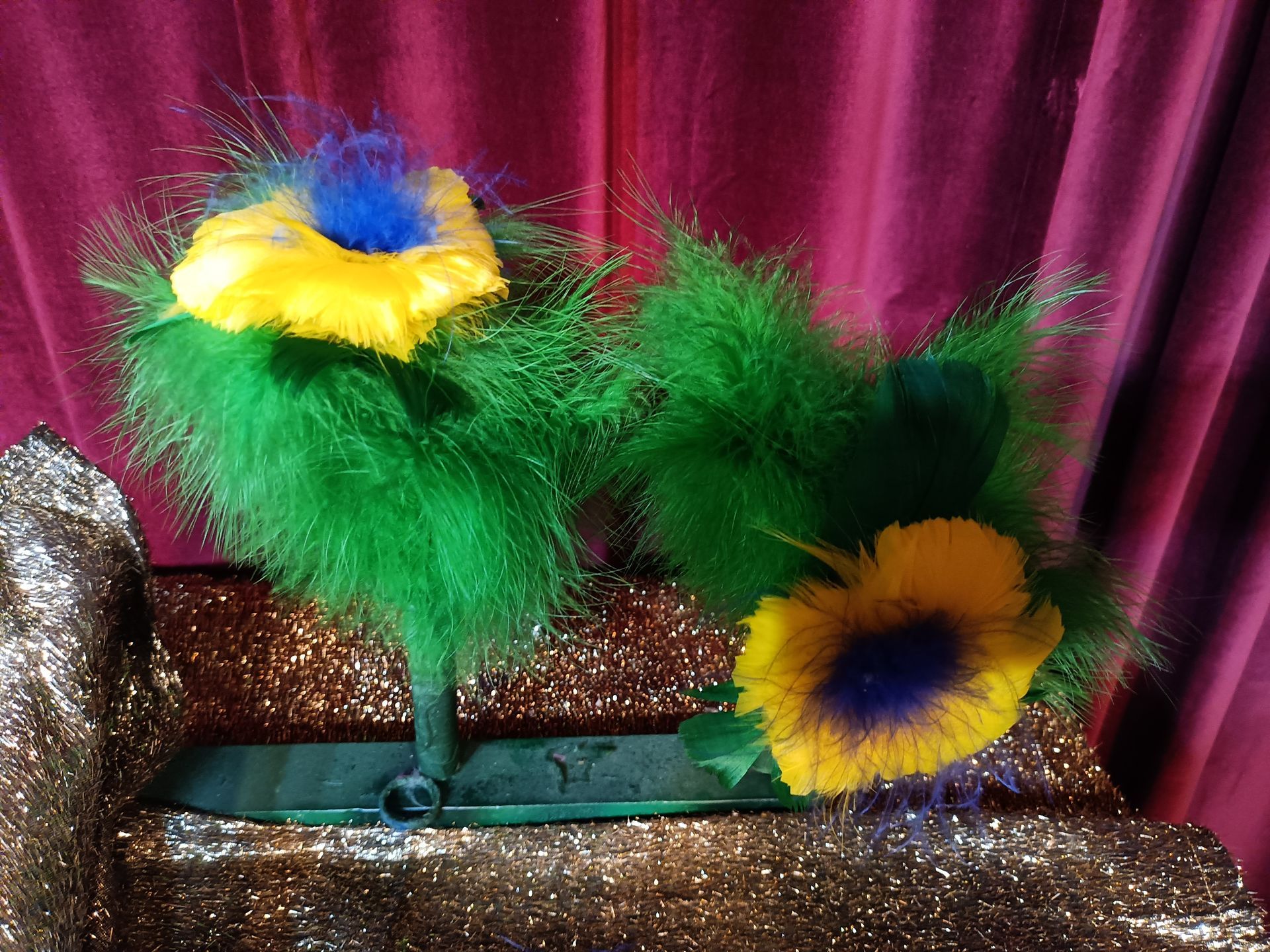A bunch of feathers with yellow and blue flowers on them