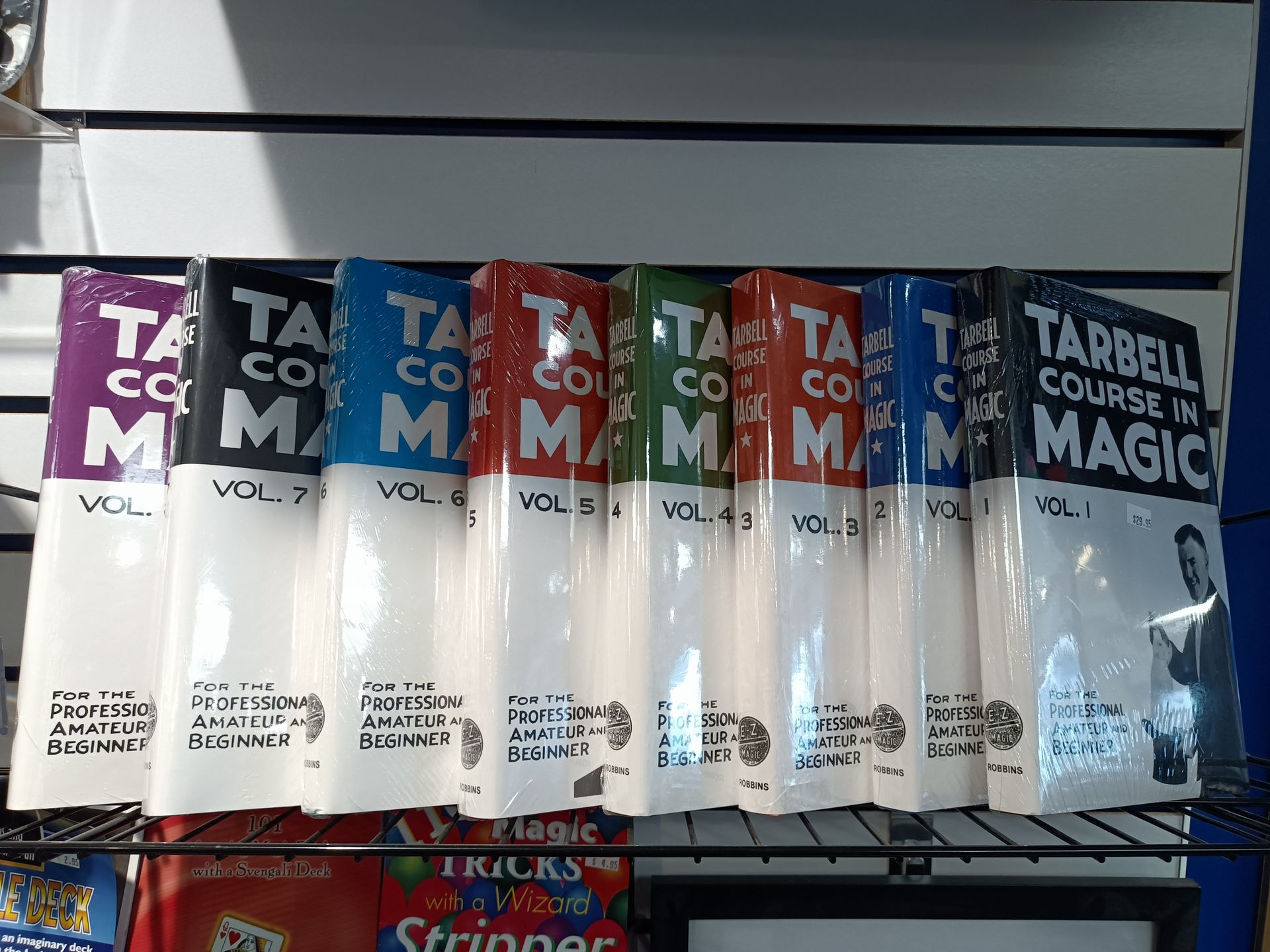 A shelf full of tarbell 's course in magic books