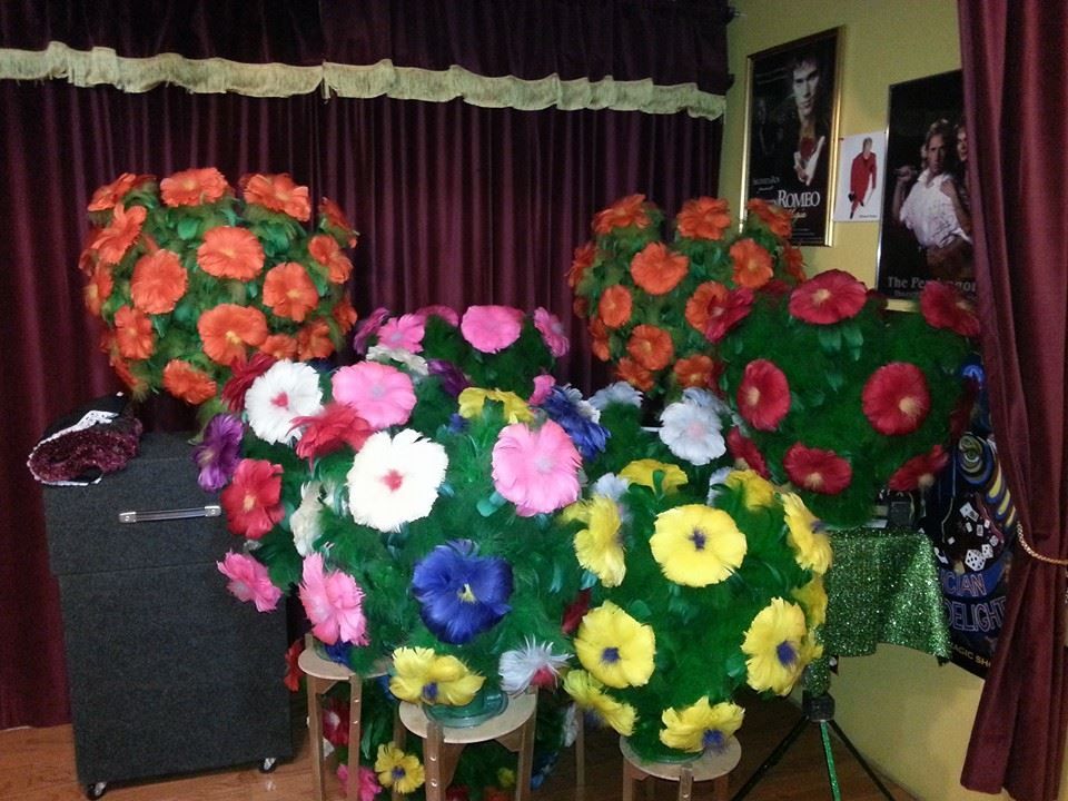 A bunch of flowers are sitting on a table in a room