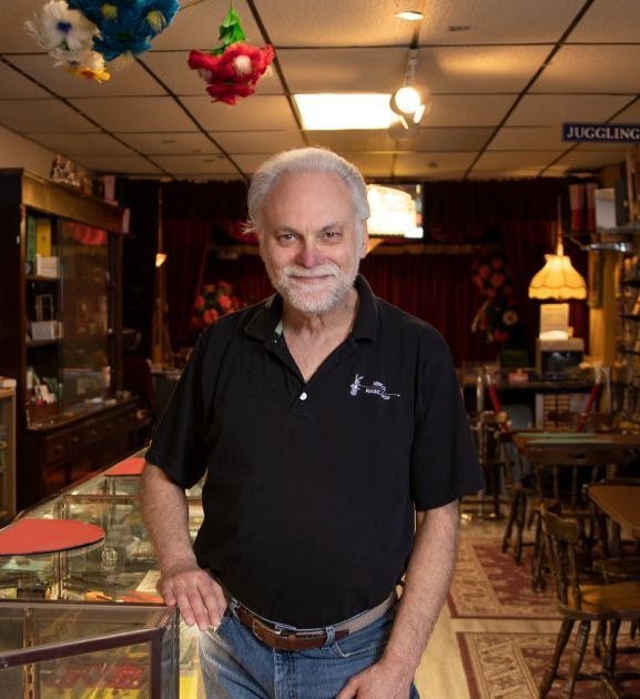 A man in a black shirt is standing in a store