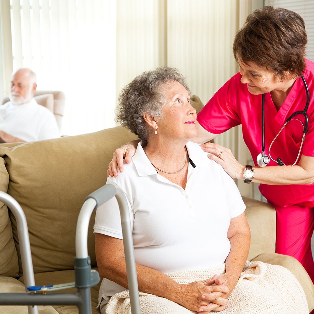 elderly woman talking to nurse