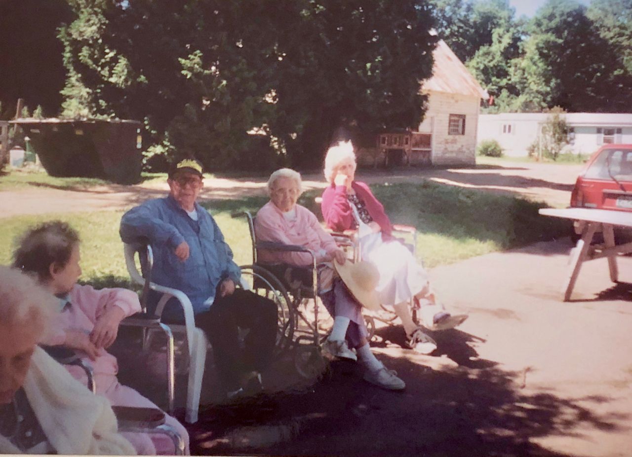 Early residents with Barn and Mobile Home in Background