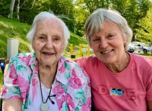 Two older women are posing for a picture together.