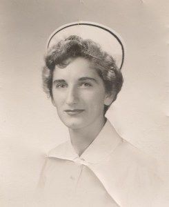 A black and white photo of a nurse wearing a hat.