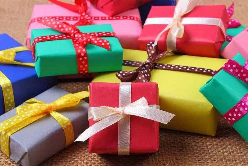 A bunch of colorful gift boxes with bows on them