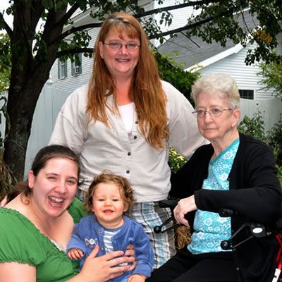 A woman in a wheelchair is holding a baby